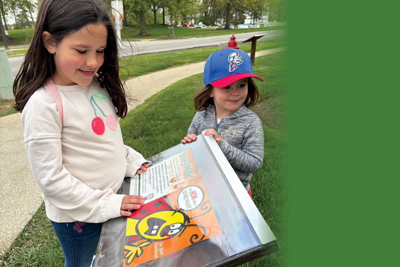 two kids reading the story walk