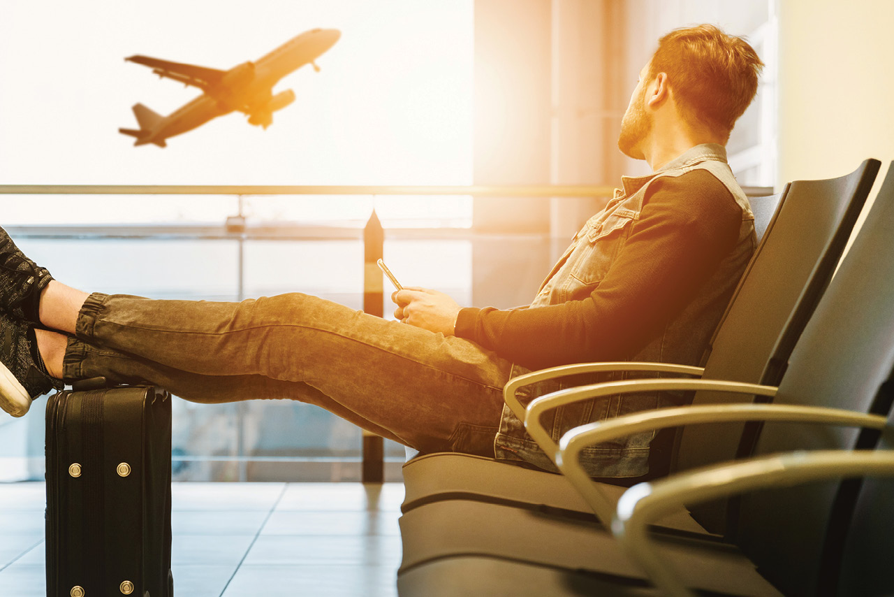 man watching a plane take off