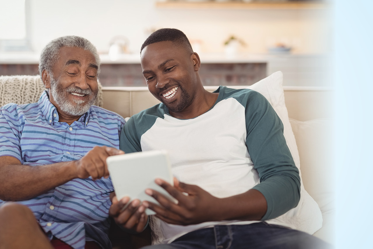 two people reading something and laughing